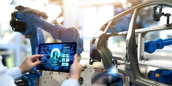 Image showing man using technology to check the manufacturing process of a car