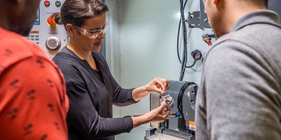 Instructor teaching students in CNC lab 