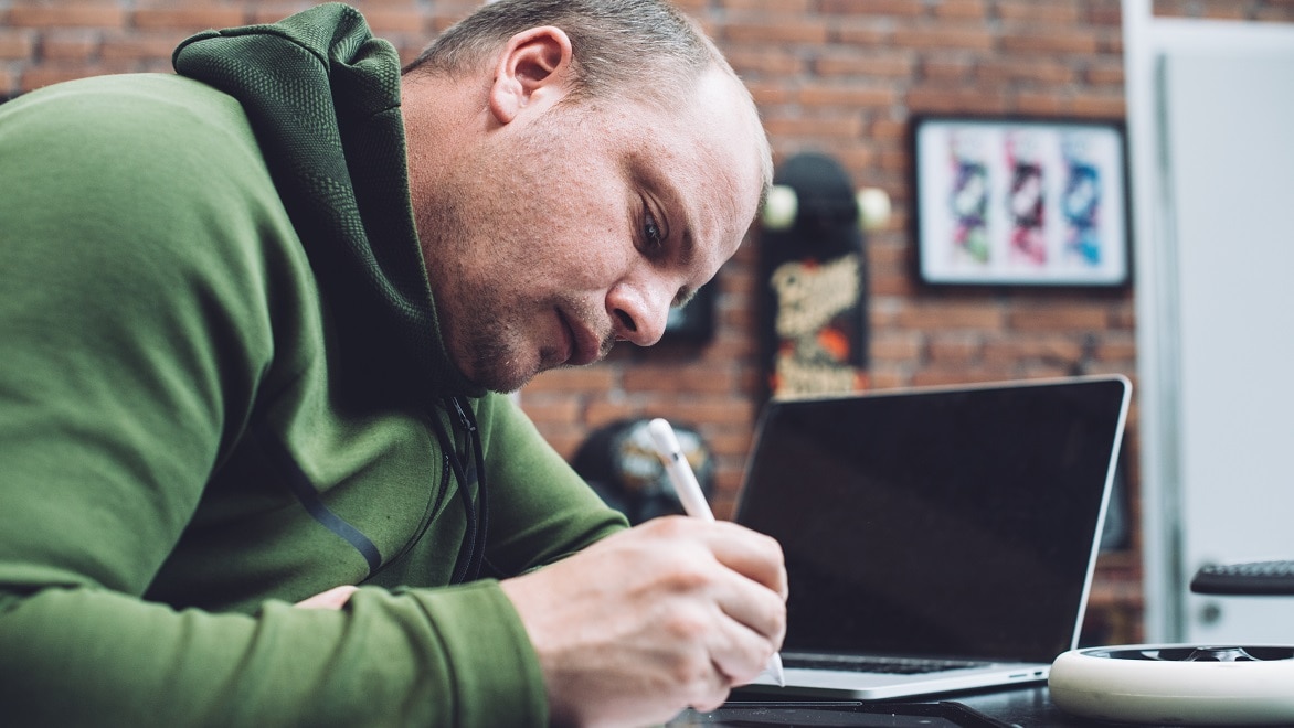 Designer Charles Cambianica uses a stylus to draw on a tablet.