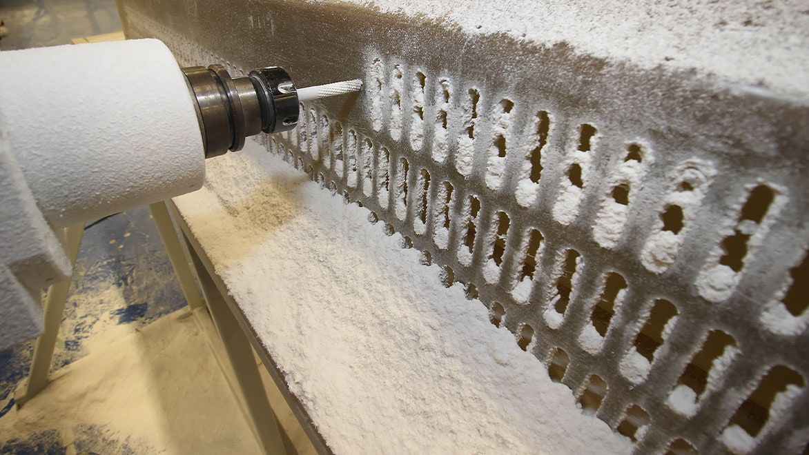 Close-up image showing the CNC machining of pockets on a fibre-glass component