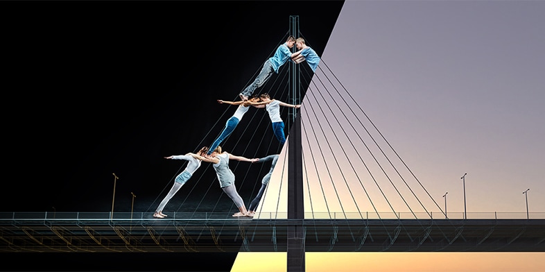 Acrobats balancing on a truss