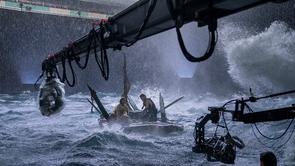 Cameras on booms film a scene of a shipwreck in a storm from The Rings of Power