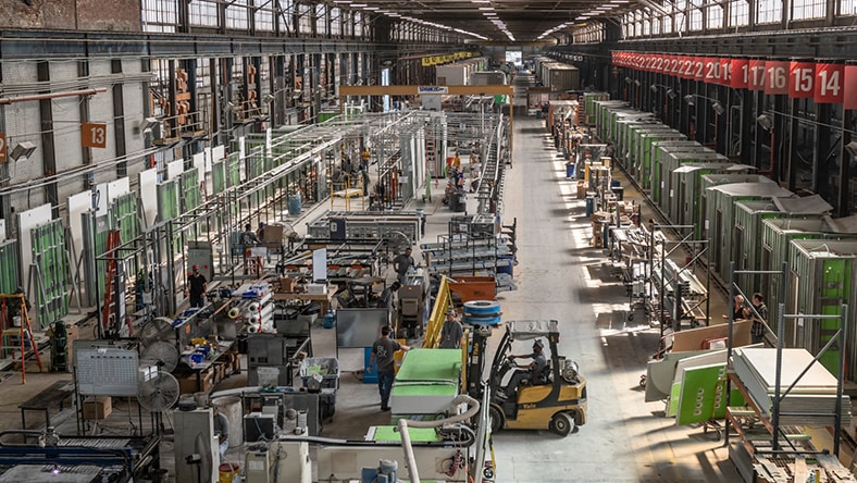 People and machines at work in a large warehouse
