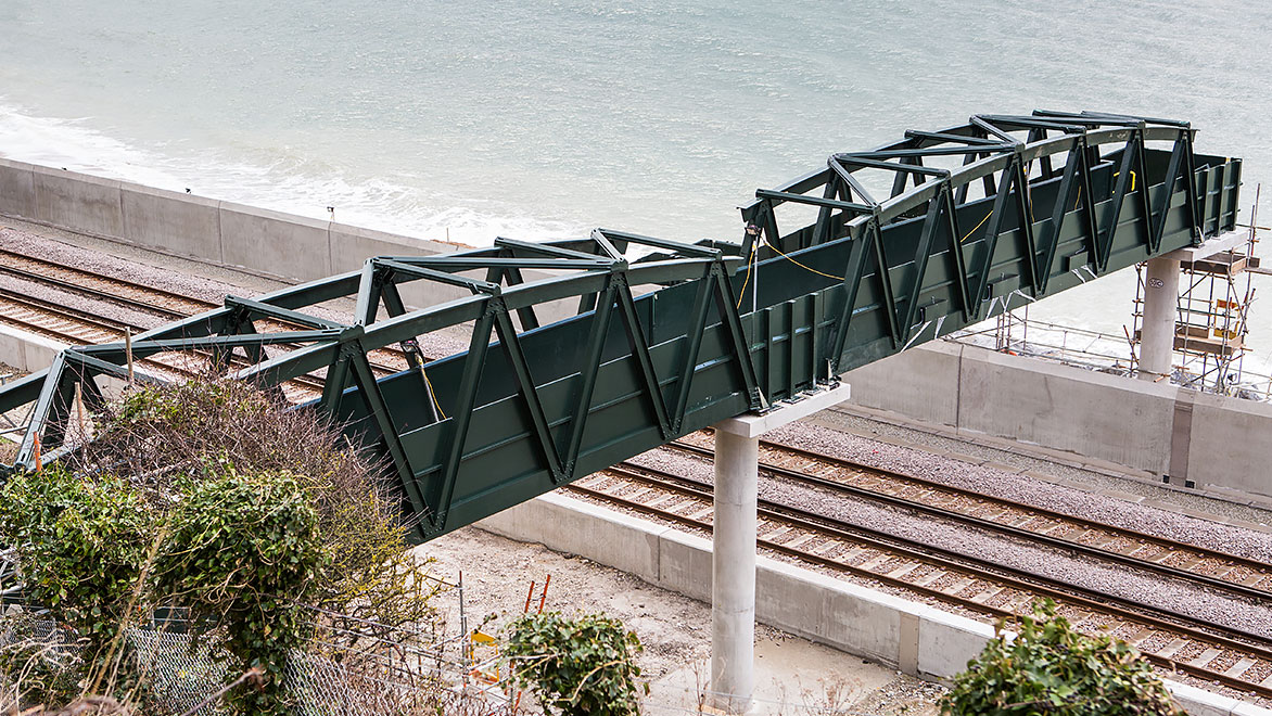 Image of fibre-glass footbridged designed and manufactured by NOV FGS and installed on the coast of Devon in the UK.